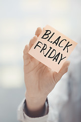 Image showing Woman holding adhesive note Black Friday text