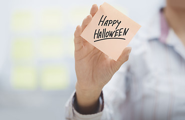 Image showing Woman holding agenda with Happy Halloween text