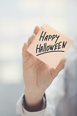 Image showing Woman holding agenda with Happy Halloween text