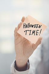 Image showing Woman holding agenda with Halloween time text