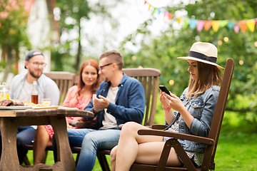 Image showing woman with smartphone and friends at summer party