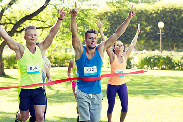 Image showing happy young male runner winning on race finish