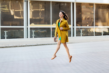 Image showing happy young woman or teenage girl on city street