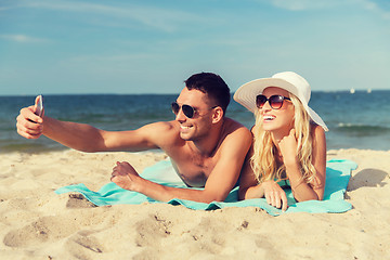 Image showing happy couple in swimwear walking on summer beach