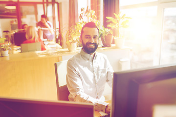 Image showing happy creative male office worker with computer
