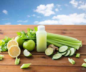 Image showing close up of bottle with green juice and vegetables