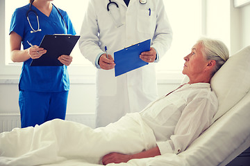 Image showing doctor and nurse visiting senior woman at hospital