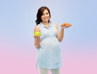 Image showing happy pregnant woman with apple and croissant