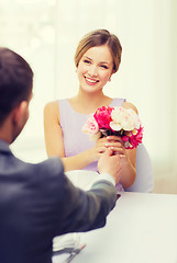 Image showing smiling woman recieving bouquet of flowers