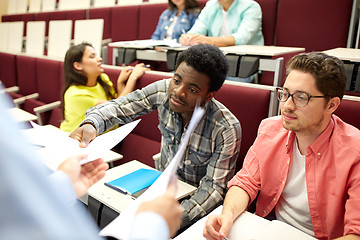 Image showing teacher giving tests to students at lecture