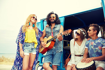 Image showing happy hippie friends playing music over minivan