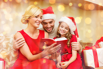 Image showing smiling family reading book