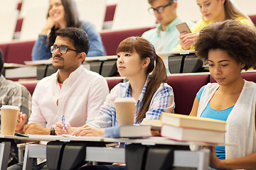 Image showing group of students with notebooks on lecture