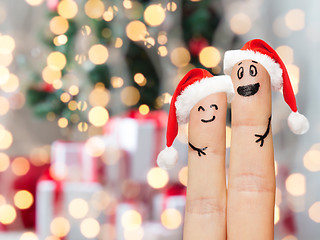 Image showing close up of two fingers with smiley and santa hats