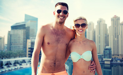 Image showing happy couple in swimwear over dubai city waterside