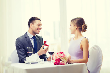 Image showing man proposing to his girlfriend at restaurant