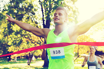 Image showing happy young male runner winning on race finish