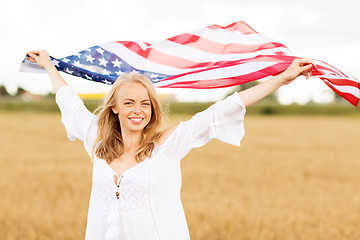 Image showing happy woman with american flag on cereal field