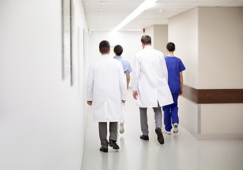 Image showing group of medics or doctors walking along hospital