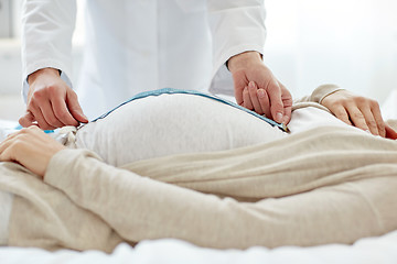 Image showing close up of doctor and pregnant woman at hospital