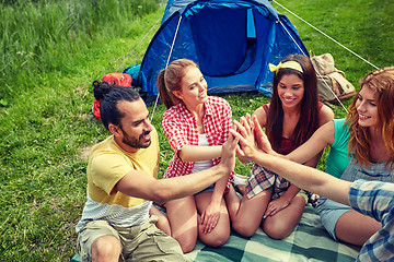 Image showing happy friends making high five at camping