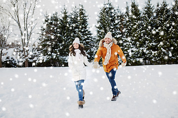 Image showing happy couple running in winter snow