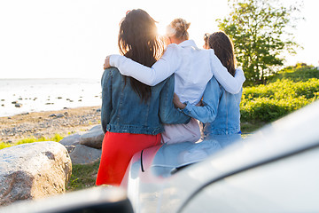 Image showing happy teenage girls or women near car at seaside