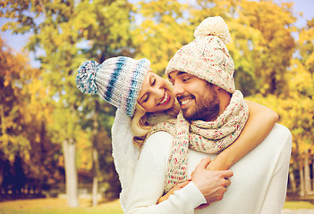 Image showing happy couple in warm clothes over autumn