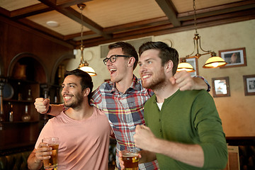 Image showing friends with beer watching sport at bar or pub