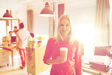 Image showing happy creative woman with coffee cup at office