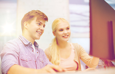 Image showing smiling teenage boy and girl in computer class