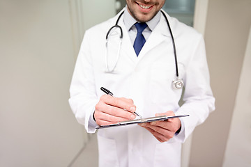 Image showing close up of doctor with clipboard at hospital