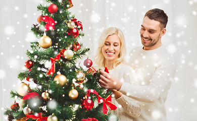 Image showing happy couple decorating christmas tree at home