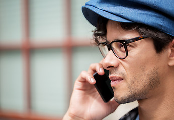 Image showing close up of man with smartphone calling on street