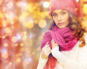 Image showing woman in hat and scarf over christmas  lights