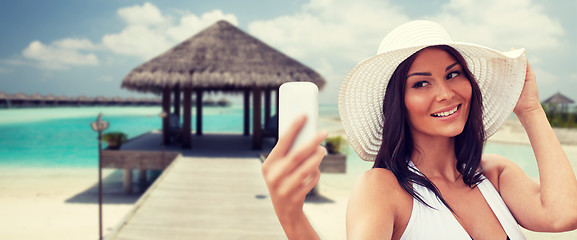 Image showing young woman taking selfie with smartphone