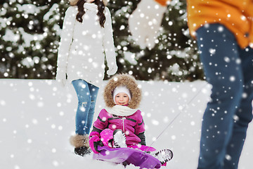 Image showing happy family with sled walking in winter forest