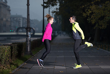 Image showing couple warming up before jogging