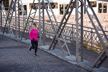 Image showing sporty woman jogging on morning