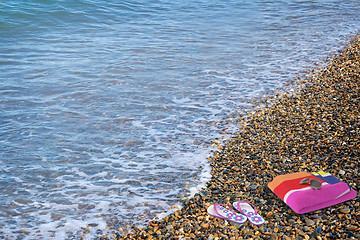 Image showing Beach shoes and a towel on the beach.