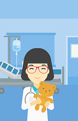 Image showing Pediatrician doctor holding teddy bear.