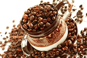 Image showing Cup of coffee beans on white