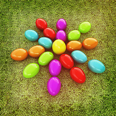 Image showing Colored Easter eggs as a flower on a green grass. 3D illustratio