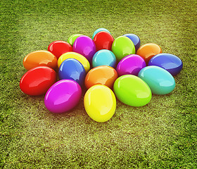 Image showing Colored Easter eggs on a green grass. 3D illustration. Vintage s