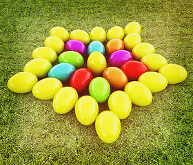 Image showing Colored Easter eggs as a flower on a green grass. 3D illustratio