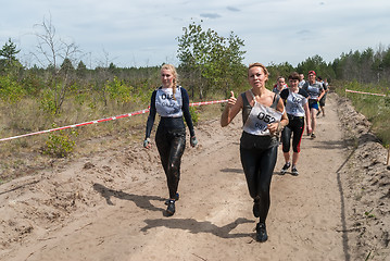 Image showing Sportsmen run between stages in extrim race.Tyumen