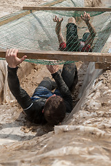 Image showing Men creep on an entrenchment with sand and water