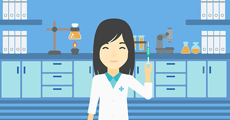 Image showing Laboratory assistant with syringe in lab.