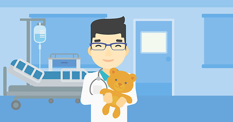 Image showing Pediatrician doctor holding teddy bear.