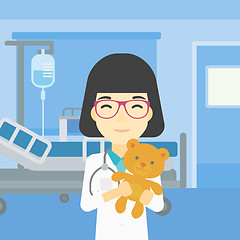 Image showing Pediatrician doctor holding teddy bear.